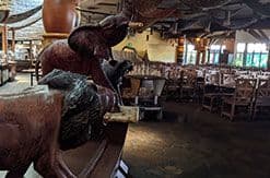 Spacious Disney resort lounge with leather seating, warm lighting, and guests relaxing in a comfortable indoor setting.