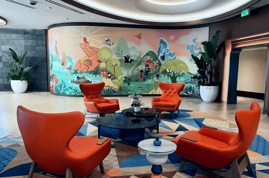 Villas At Disneyland Hotel lobby area with beautiful mural featuring multiple Disney movie classics
